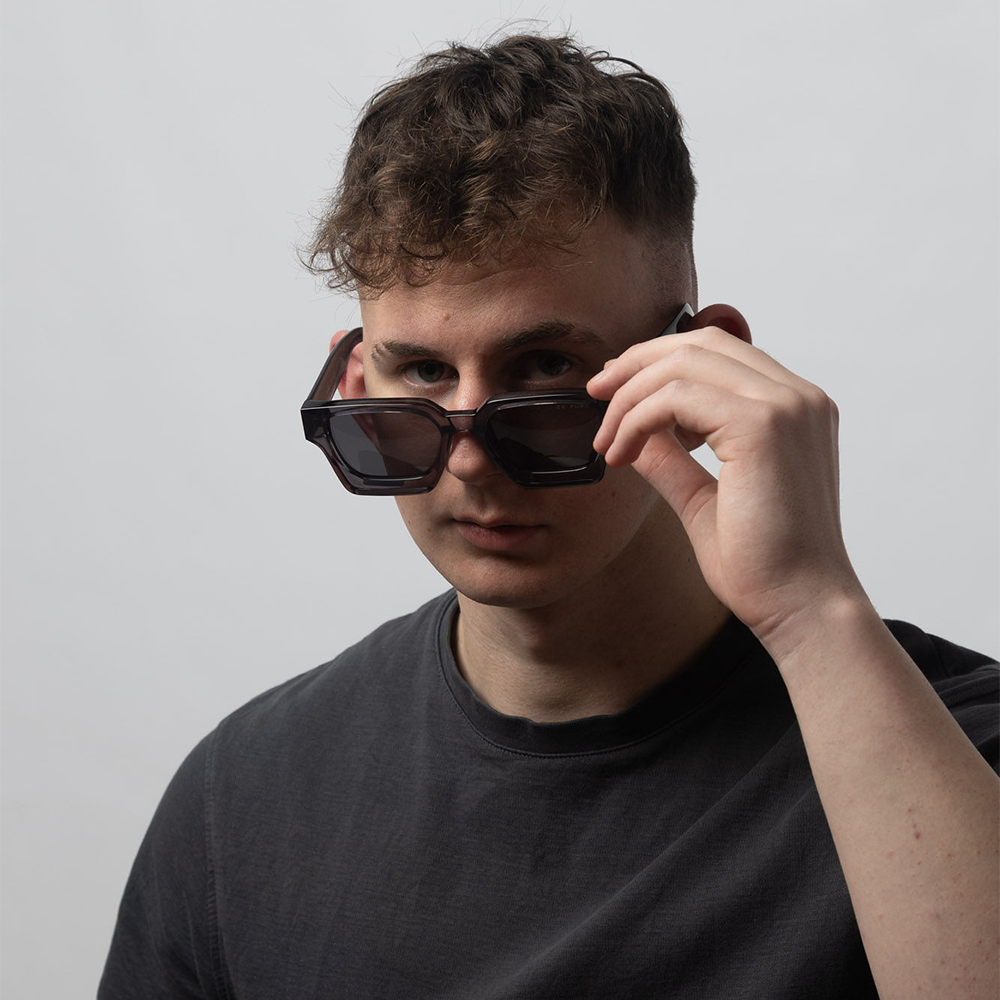 Person wearing sunglasses with a neutral background